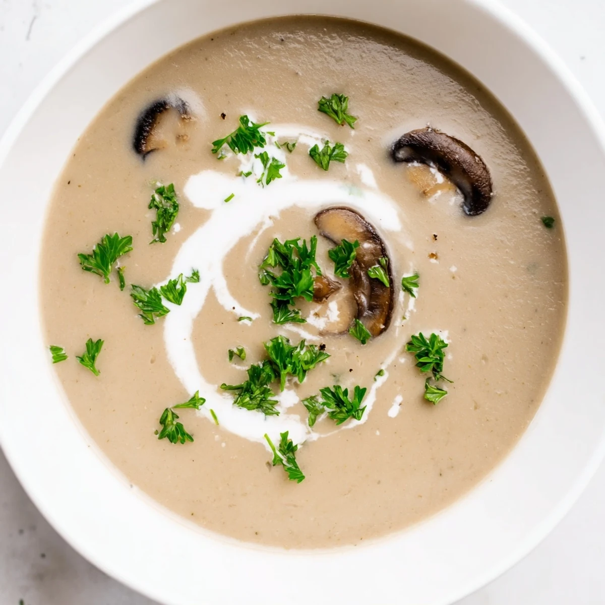 Steaming bowl of Creamy Mushroom Soup with Thyme beside crusty artisan bread, perfect for a cozy vegetarian dinner.