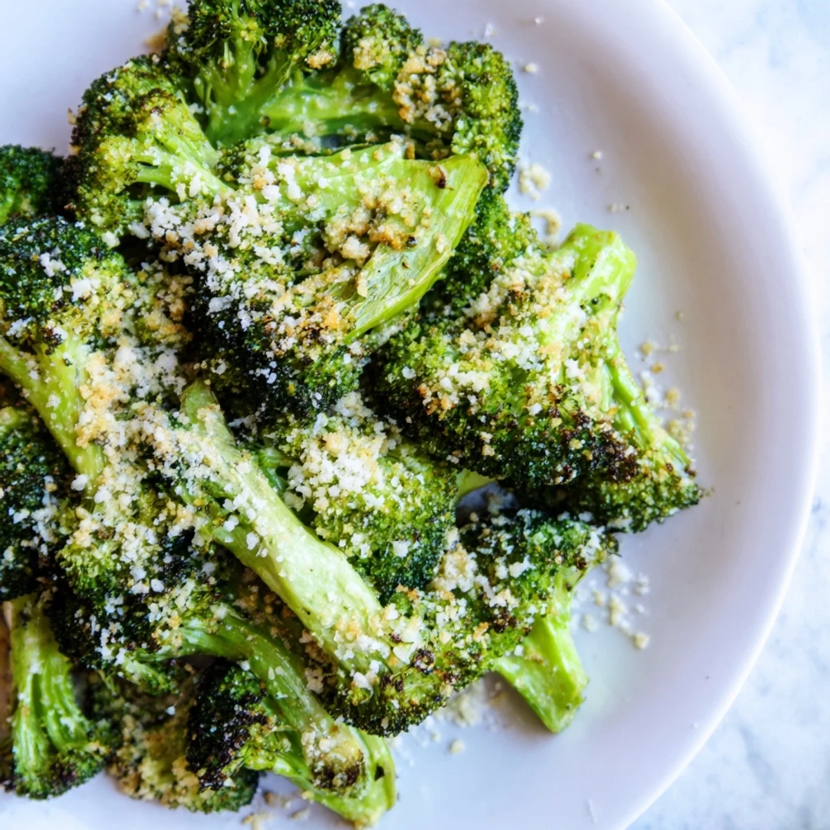 Crisp-tender Roasted Broccoli with Garlic and Parmesan, golden on edges, served alongside grilled chicken for an easy weeknight dinner.