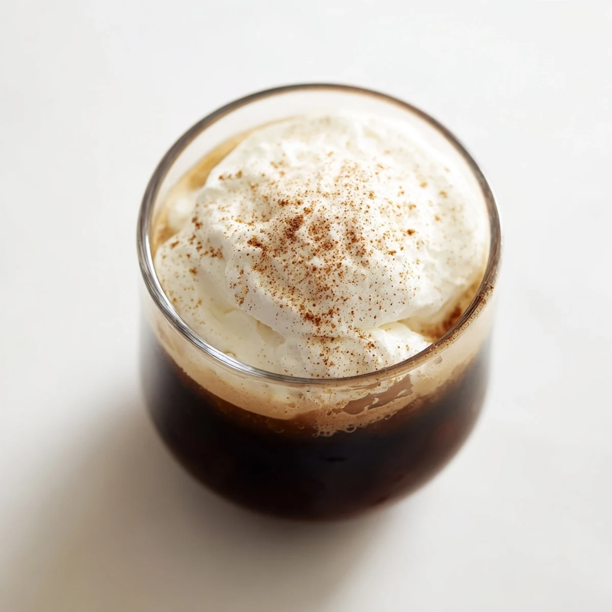 Irish Coffee Mocktail with Whipped Cream served in a glass mug, pairing perfectly with shortbread cookies.