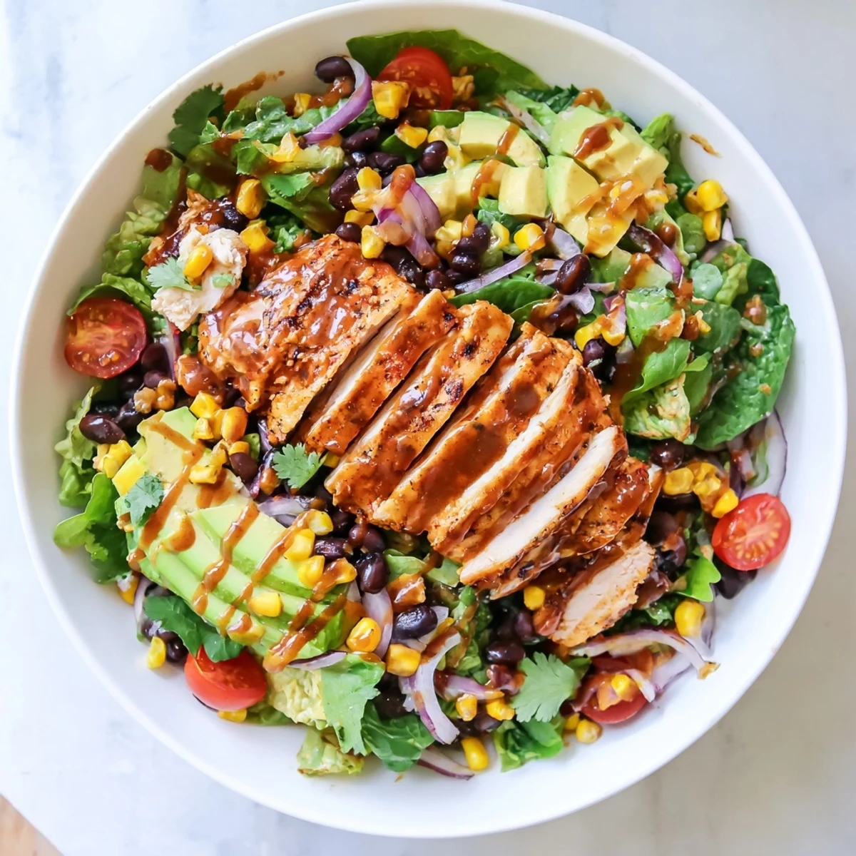 In this colorful chipotle lime chicken salad, tender marinated chicken breast is paired with creamy avocado and crisp vegetables, making a perfect gluten-free protein-packed meal for lunch or dinner.