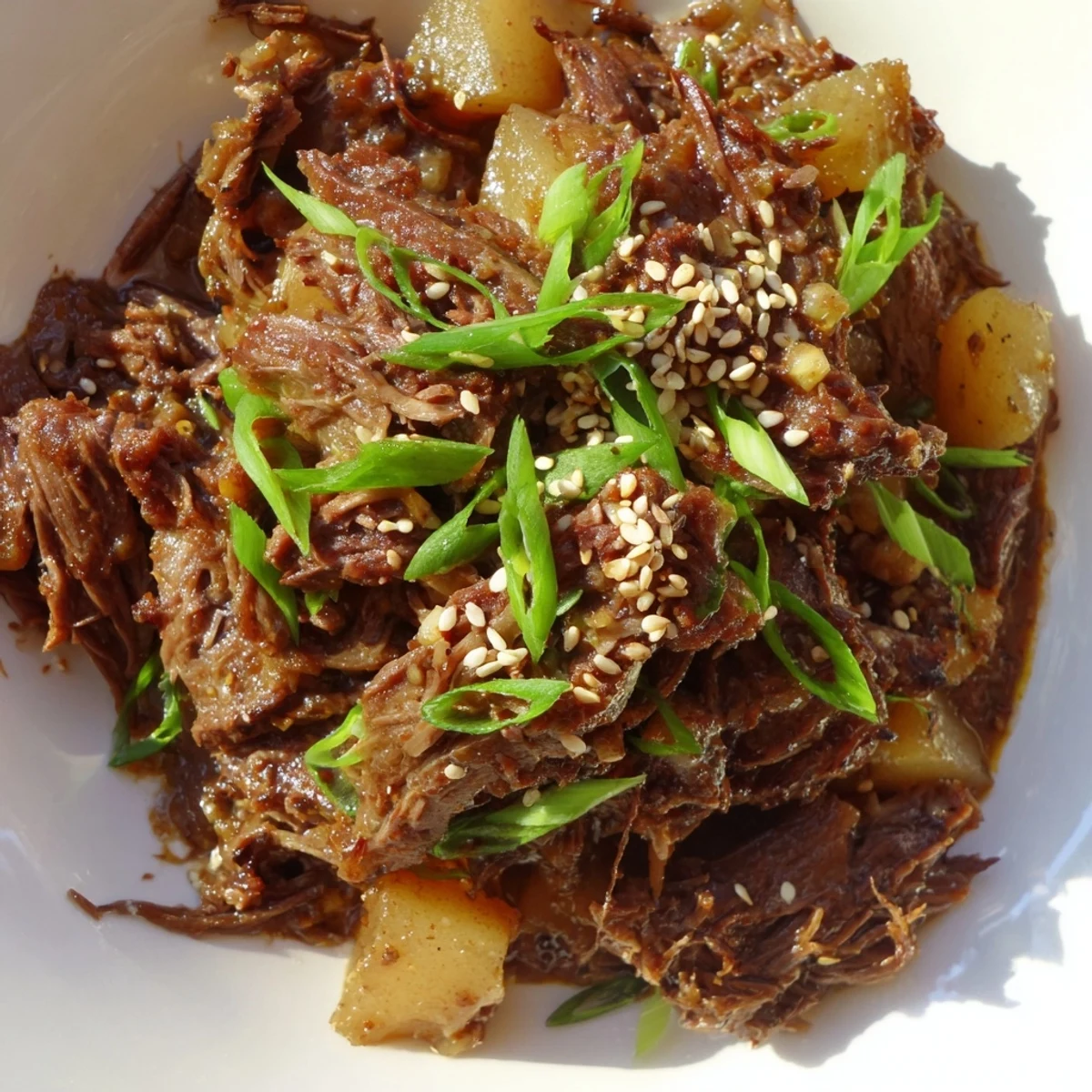 Easy Crock Pot Korean Beef recipe served family-style in a bowl, with succulent beef chunks and colorful toppings for a delicious weeknight dinner.