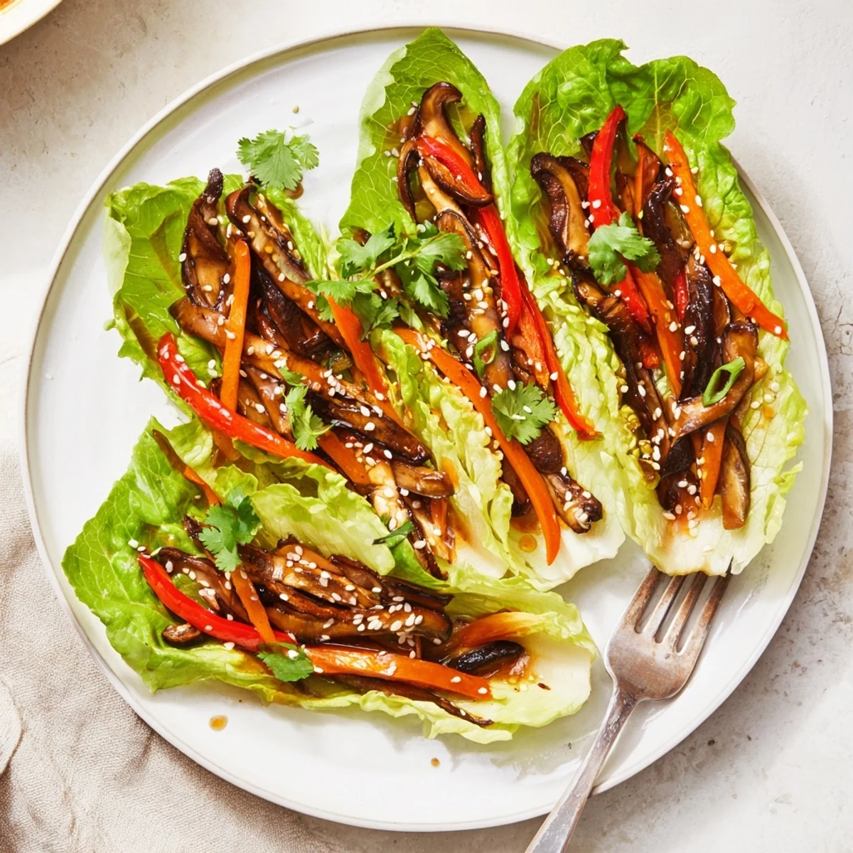 Savory shiitake mushroom lettuce wraps filled with crisp greens and fresh veggies, served warm as a light Asian appetizer.