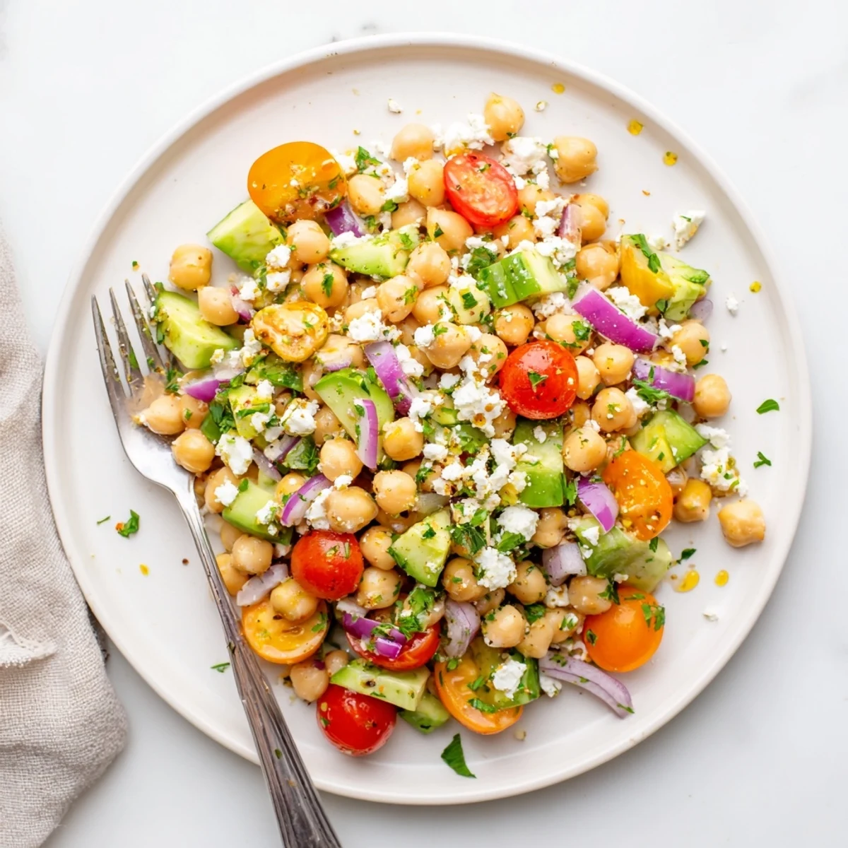 This Chickpea Feta Avocado Salad features diced avocado and chickpeas mixed with crisp red onion and herbs.