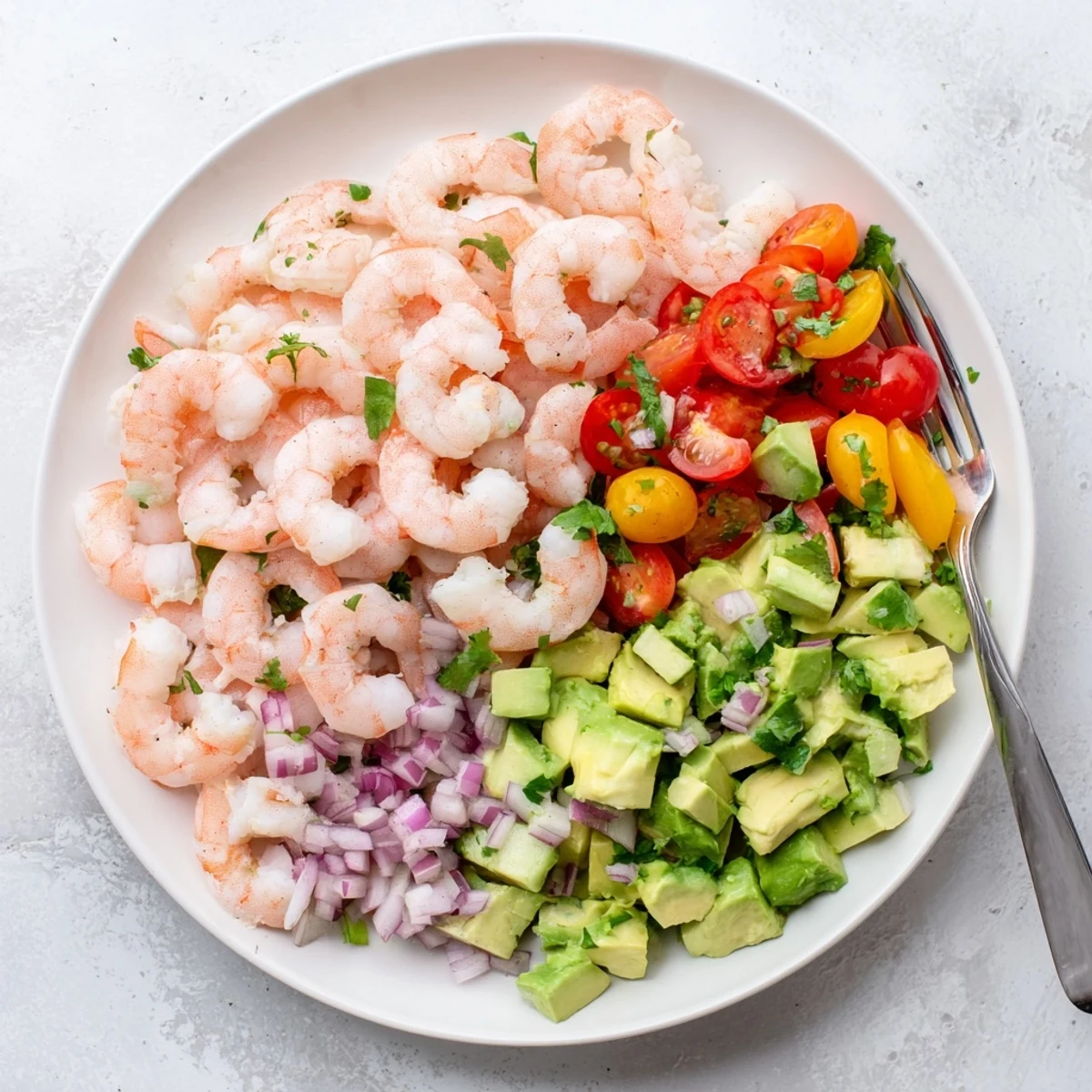 Vibrant Healthy Shrimp Avocado Salad with chilled shrimp, diced avocado, and a zesty lime dressing, served in a glass bowl.