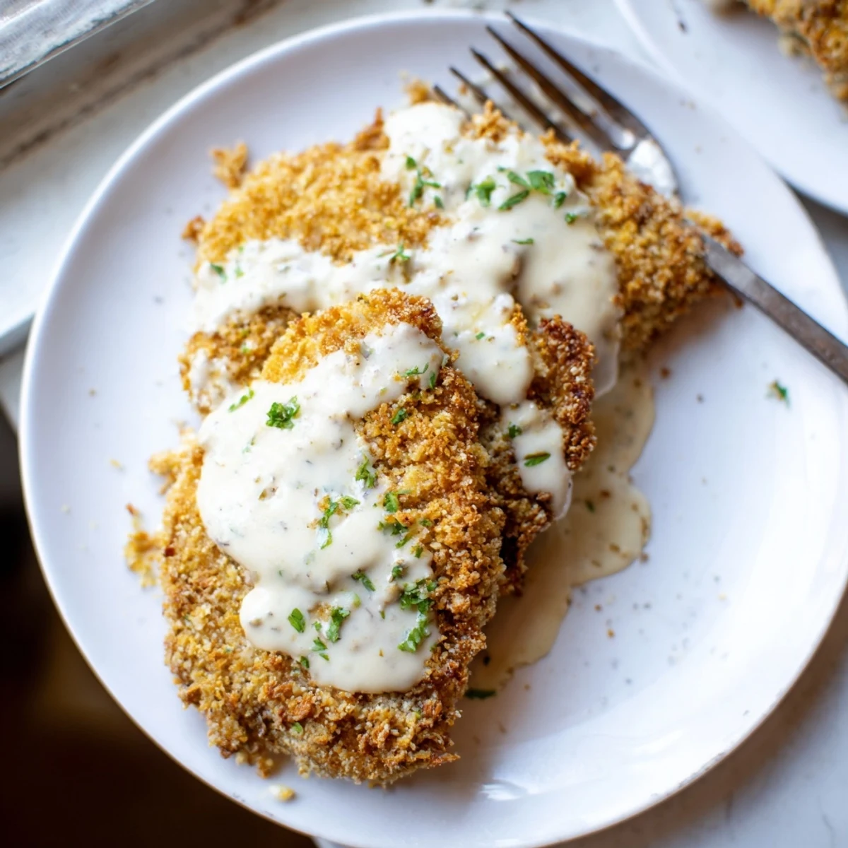 Succulent pan-seared chicken with crunchy cheese crust finished with smooth white garlic sauce perfect for family dinner