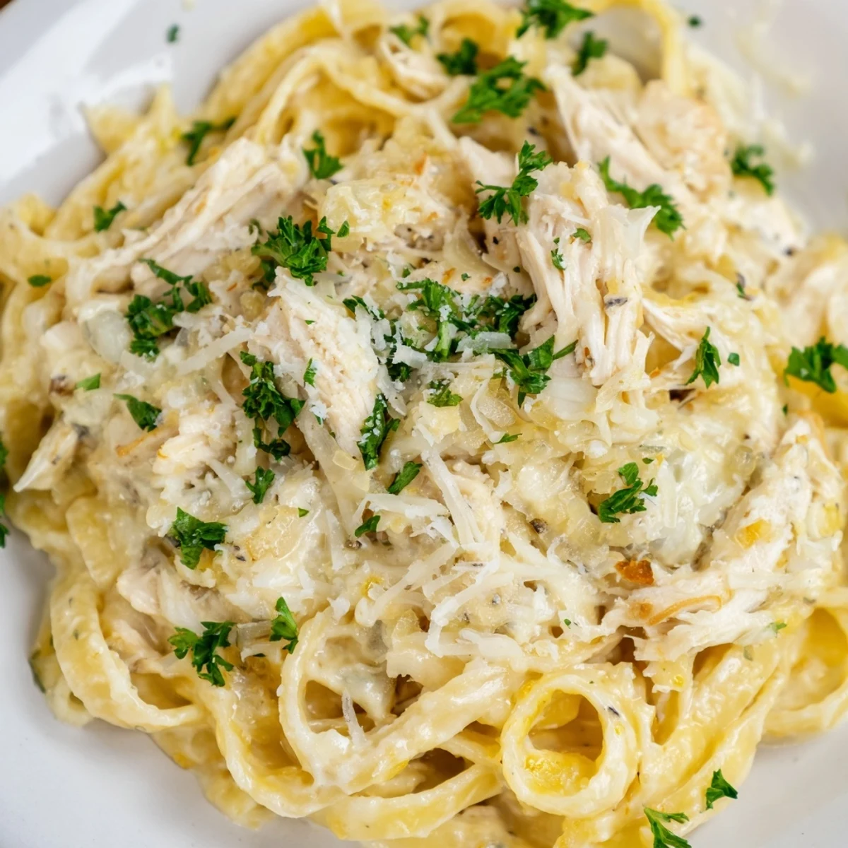Creamy Crock Pot Chicken Alfredo with tender shredded chicken and al dente fettuccine in a rich parmesan sauce