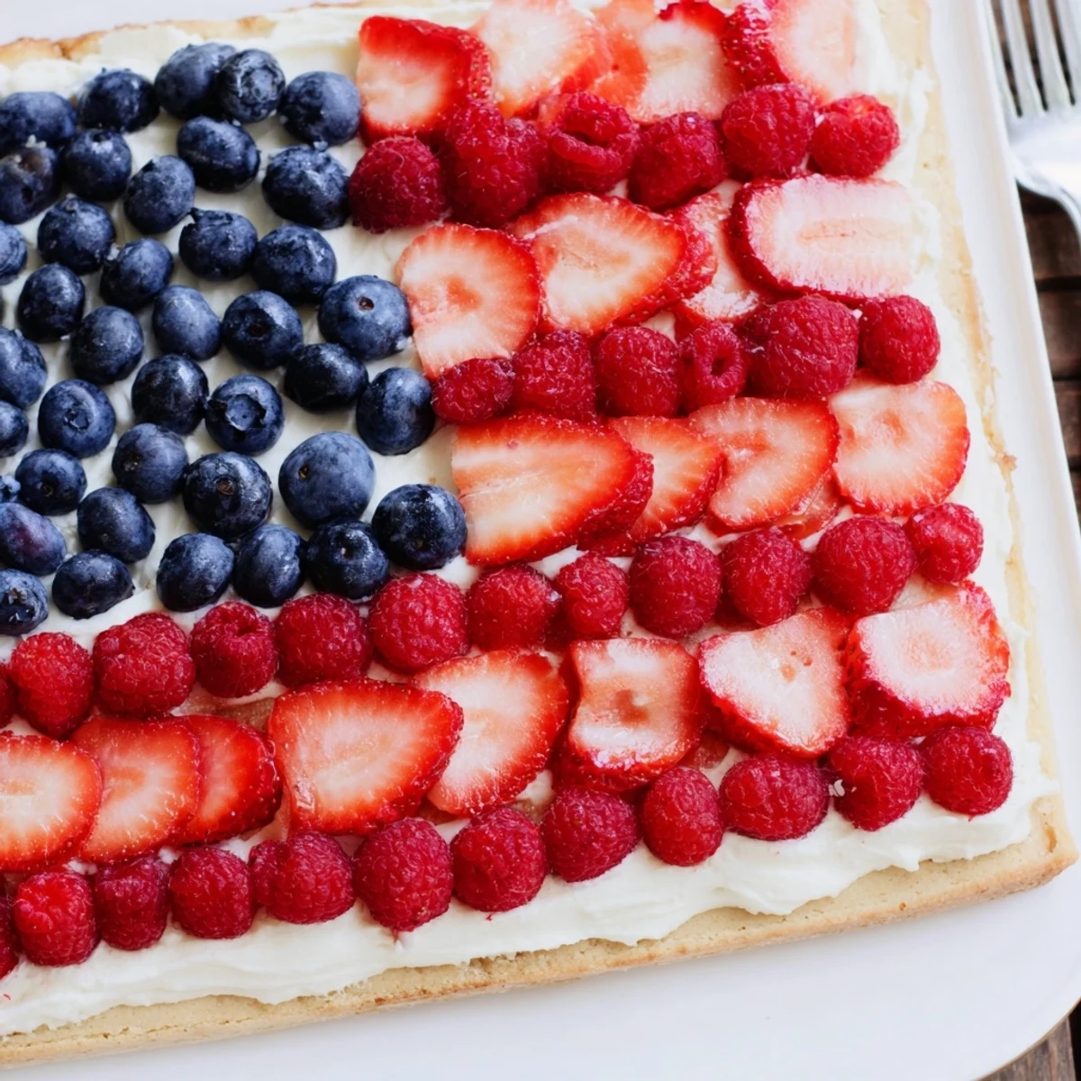 Sugar Cookie Flag Fruit Pizza topped with glossy blueberries and sliced strawberries, chilled