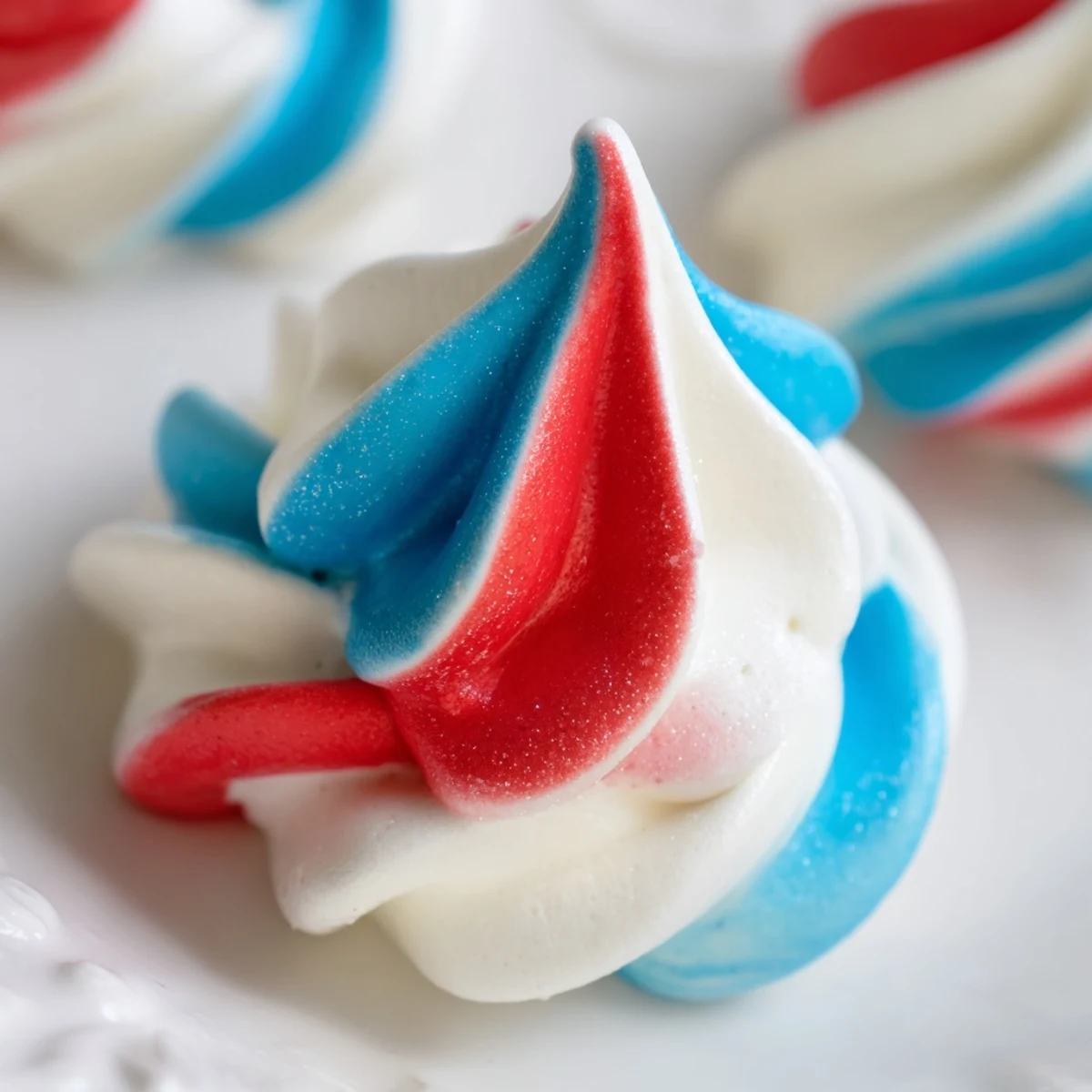 Airy Patriotic Meringue Kisses cooling on parchment, crisp edges, melt-in-mouth