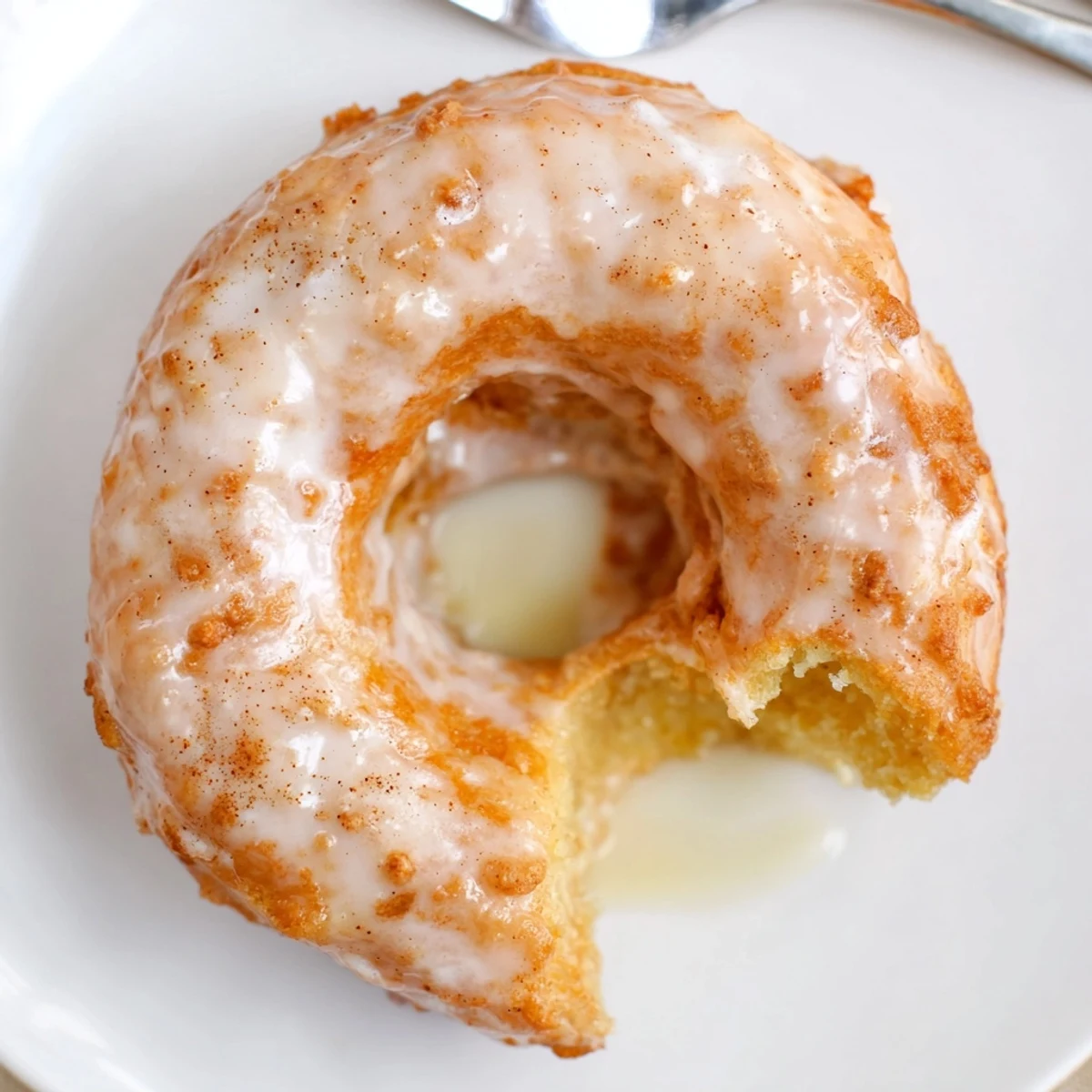 Glazed Banana Donuts piled on a plate, sweet vanilla scent wafting