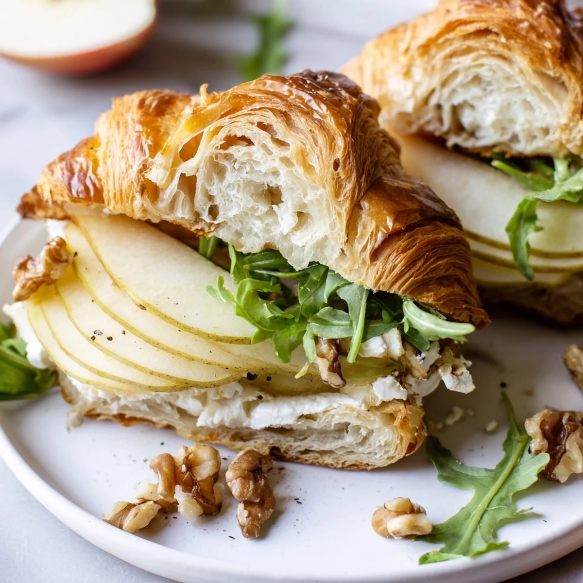 Fresh Apple Goat Cheese Croissant Sandwich layered with tangy cheese and crunchy walnuts