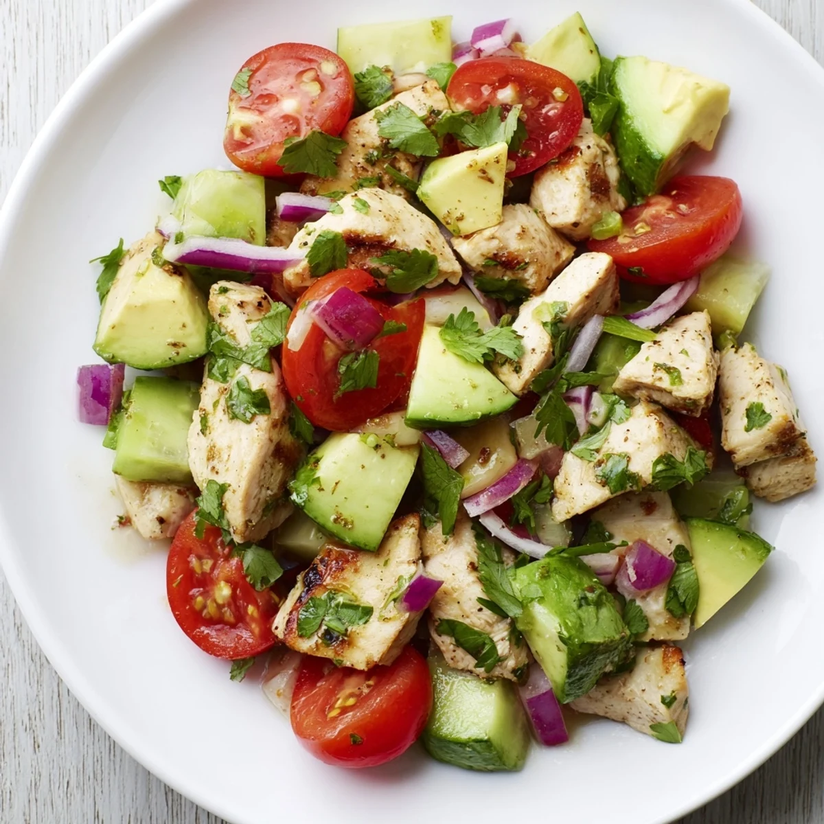Sliced grilled chicken breast arranged over ripe avocado chunks and cherry tomatoes in this Healthy Avocado Chicken Salad