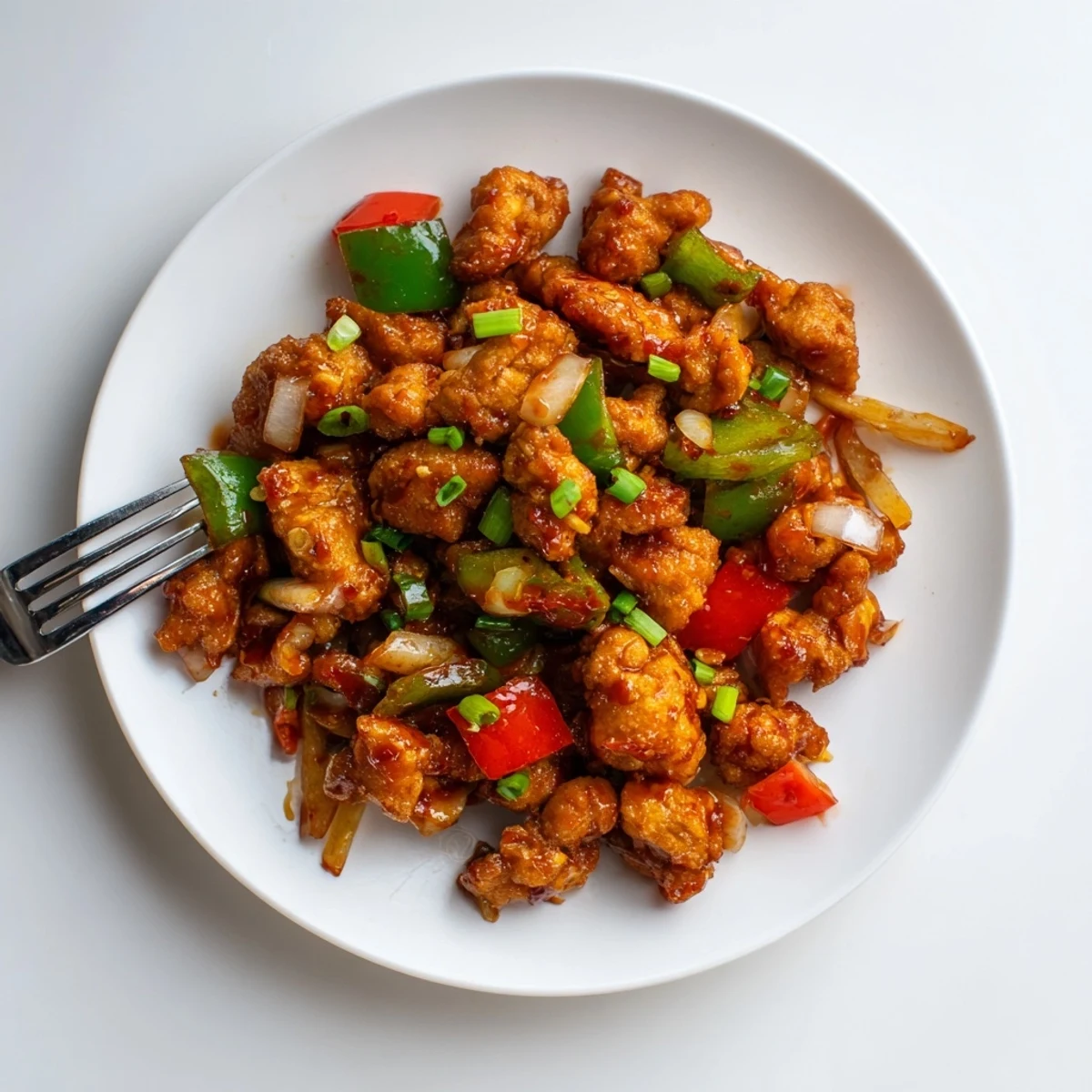 Wok-tossed Chilli Chicken Indo Chinese, glossy and spicy, served over jasmine rice.