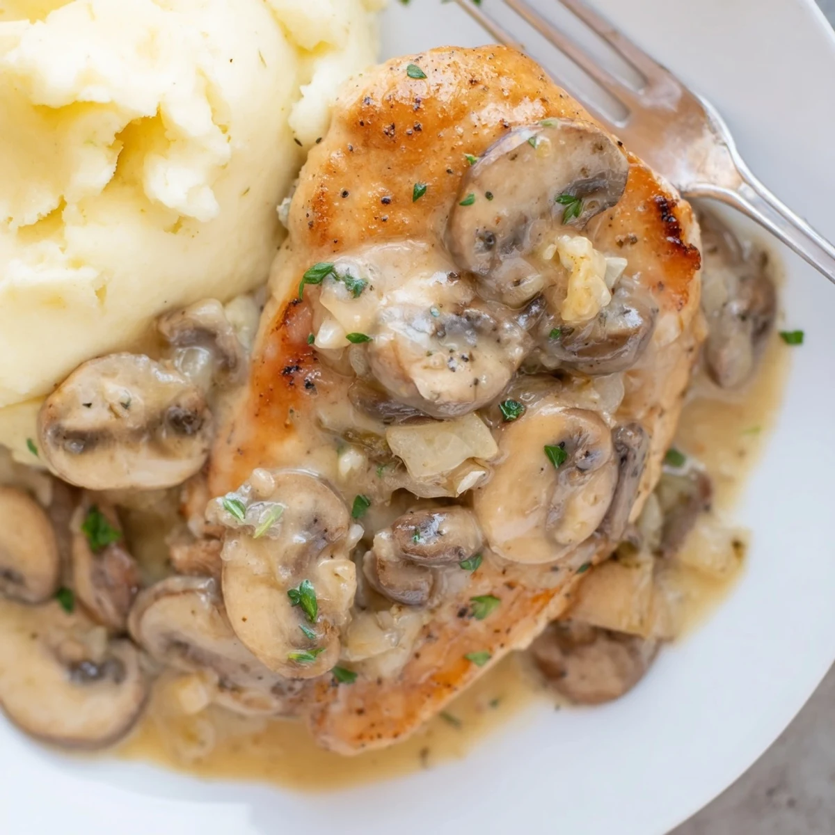 Hearty Skillet Chicken And Mushroom Sauce served hot, garnished with fresh parsley